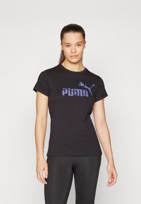 Svart bomull t-skjorte med lilla Puma-logo på brystet. Korte ermer og klassisk rund hals, tettsittende stil.