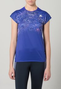 Short-sleeve athletic shirt in vibrant blue with a textured abstract pattern, featuring a round neckline and Adidas logo on the chest.