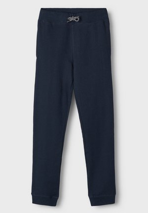 Joggers de algodón azul marino con una cinturilla elástica, cordón ajustable y piernas estrechas y ajustadas. Textura suave y diseño minimalista.