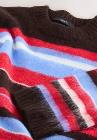 Brown, red, blue, and white striped sweater with a ribbed crew neck; features soft, textured fabric with some loose fibers visible.