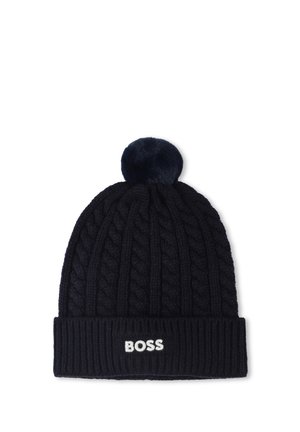 Navy knitted beanie with a cable pattern, ribbed cuff, and a fluffy pom-pom on top. "BOSS" logo displayed on the cuff in white.