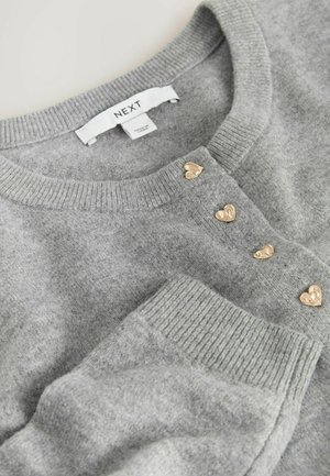 Gray knit cardigan with a round neckline, featuring gold heart-shaped buttons along the front and ribbed cuffs for texture. Tag visible.