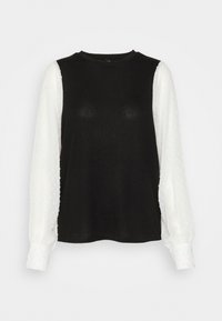 Bodice nero con maniche lunghe bianche; le maniche presentano un motivo a pois testurizzato. Collo rotondo e polsini arricciati. Texture del tessuto morbida.