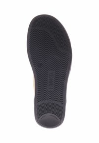 Schoenzool van gestructureerd zwart rubbermateriaal, met een golvend profiel en gegraveerde tekst: "SCHOKDENSOR" en "FINN CO."