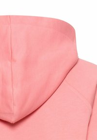 Pink hoodie with a soft texture, featuring a rounded hood and seamless shoulder design. Fabric appears lightweight and casual.