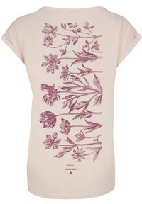 Light pink t-shirt featuring a detailed purple floral design across the back, with a relaxed fit and short sleeves.