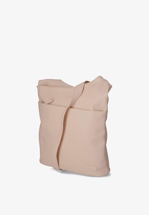 Zachte beige leren schoudertas met brede riem, voorvak en subtiele merkpatch nabij de onderkant.