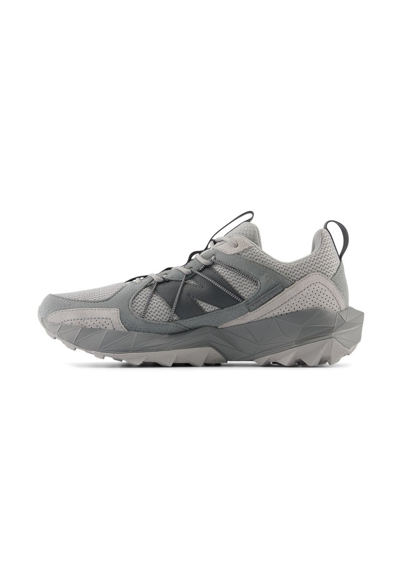 Baskets de sport grises avec une tige en mesh, des accents texturés, des lacets noirs et une semelle à motif robuste conçue pour l'adhérence.