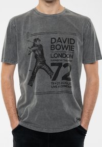 Gray cotton t-shirt featuring a distressed graphic of a musician, text includes "DAVID BOWIE," concert details, and bold accents.