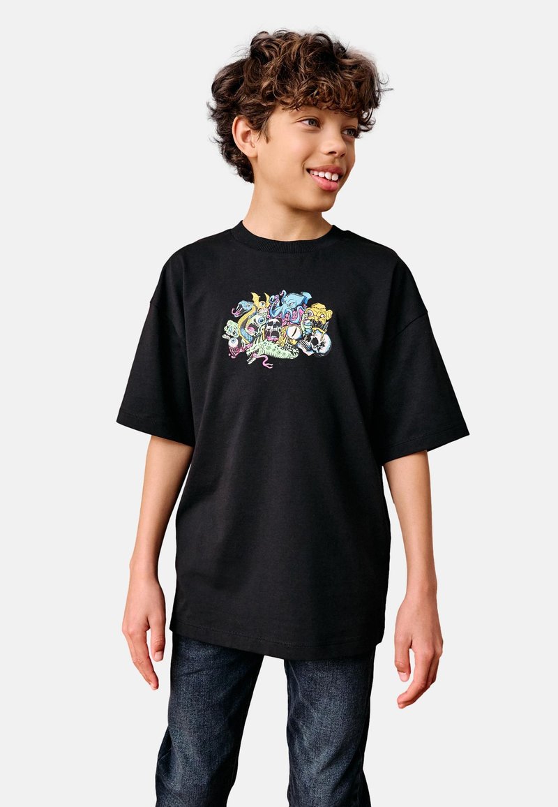 Black cotton t-shirt featuring a colorful graphic print of various cartoon animals on the front; relaxed fit with short sleeves.