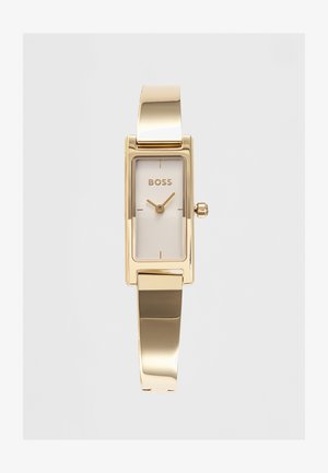 Rechthoekig horloge in goudkleur met minimalistische wijzerplaat, BOSS-logo en slanke metalen band.