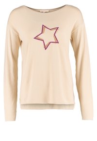 Beige Langarmoberteil aus strukturiertem Stoff mit einem lila Sternmotiv auf der Vorderseite. Subtiler Rundhalsausschnitt und lockere Passform.