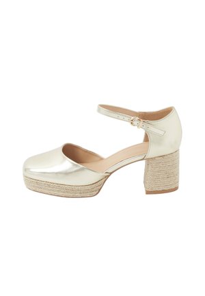 Chaussure Mary Jane pour femme de couleur crème avec bride à la cheville, bout arrondi et plateforme à talon bloc tressé.