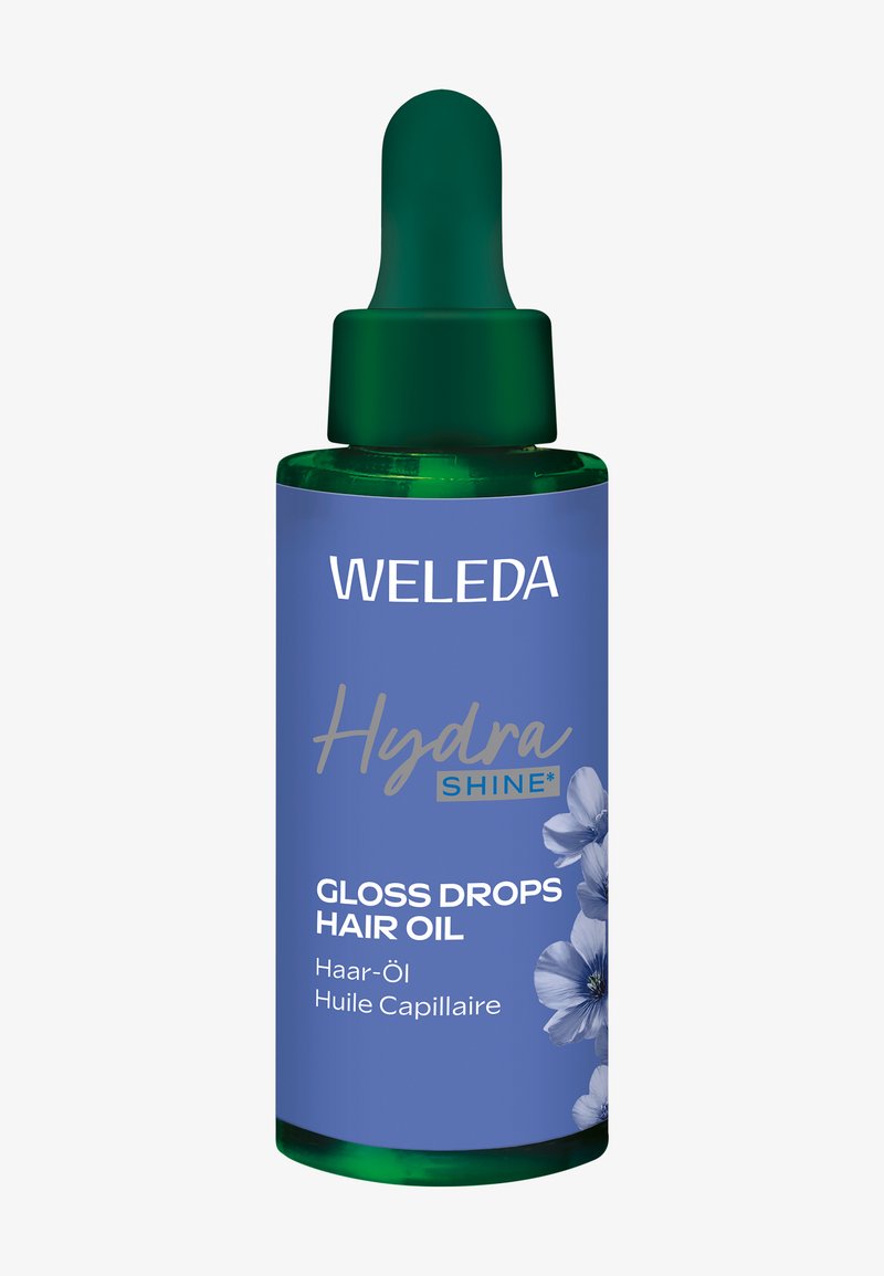 Weleda Hydra Shine Gloss Drops olejek do włosów w zielonej szklanej butelce z pipetą, z niebieską etykietą i kwiatowymi akcentami.