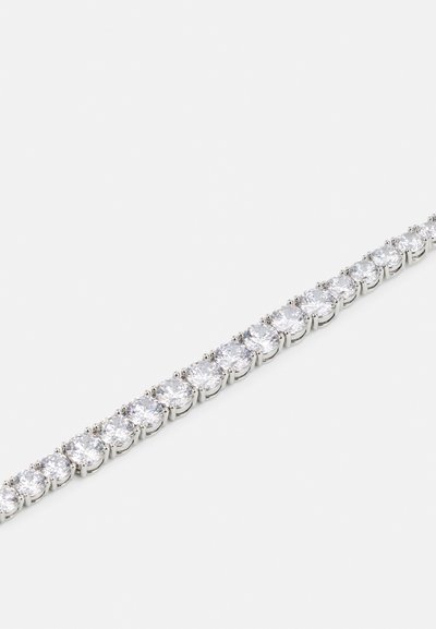 Silver bracelet featuring a line of circular clear stones set in secured prongs, showcasing a smooth, reflective finish with a delicate design.