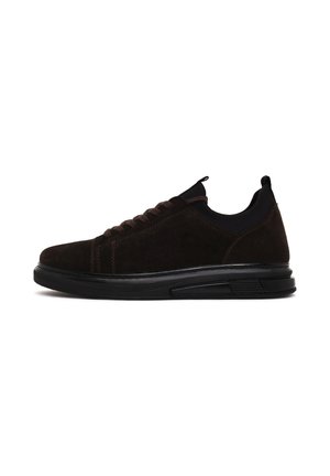 Donkerbruine suède sneaker met zwarte zool, veters aan de voorkant en treklussen op de tong en hiel, gezien vanaf de buitenkant.