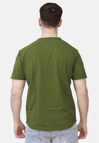 T-shirt in cotone verde con maniche corte, scollo tondo e orlo dritto; senza motivi o grafiche visibili. Adatto per un abbigliamento casual.
