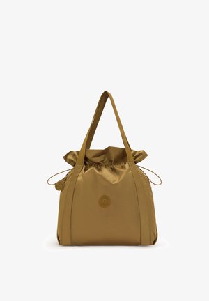 Brown nylon tote bag with two shoulder straps, drawstring closure, and a circular logo patch on the front center.