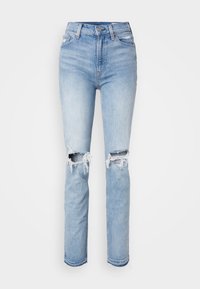 Jeans in denim blu a vita alta con strappi sbucciati sulle ginocchia, vestibilità dritta, lavaggio chiaro e dettagli con orlo sfrangiato.