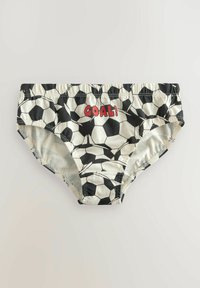 Costume da bagno a righe bianche e nere con design di palloni da calcio e un accento rosso con la scritta "GOAL!" sul davanti. Tessuto morbido, vita elastica.