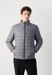 Gray puffer jacket with horizontal stitching, high collar, and zip closure. Features side pockets and a smooth, lightweight texture.
