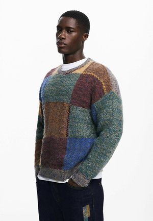 Multi-colored patchwork sweater in wool blend; featuring squares of green, blue, brown, and burgundy with textured knit details and ribbed cuffs.