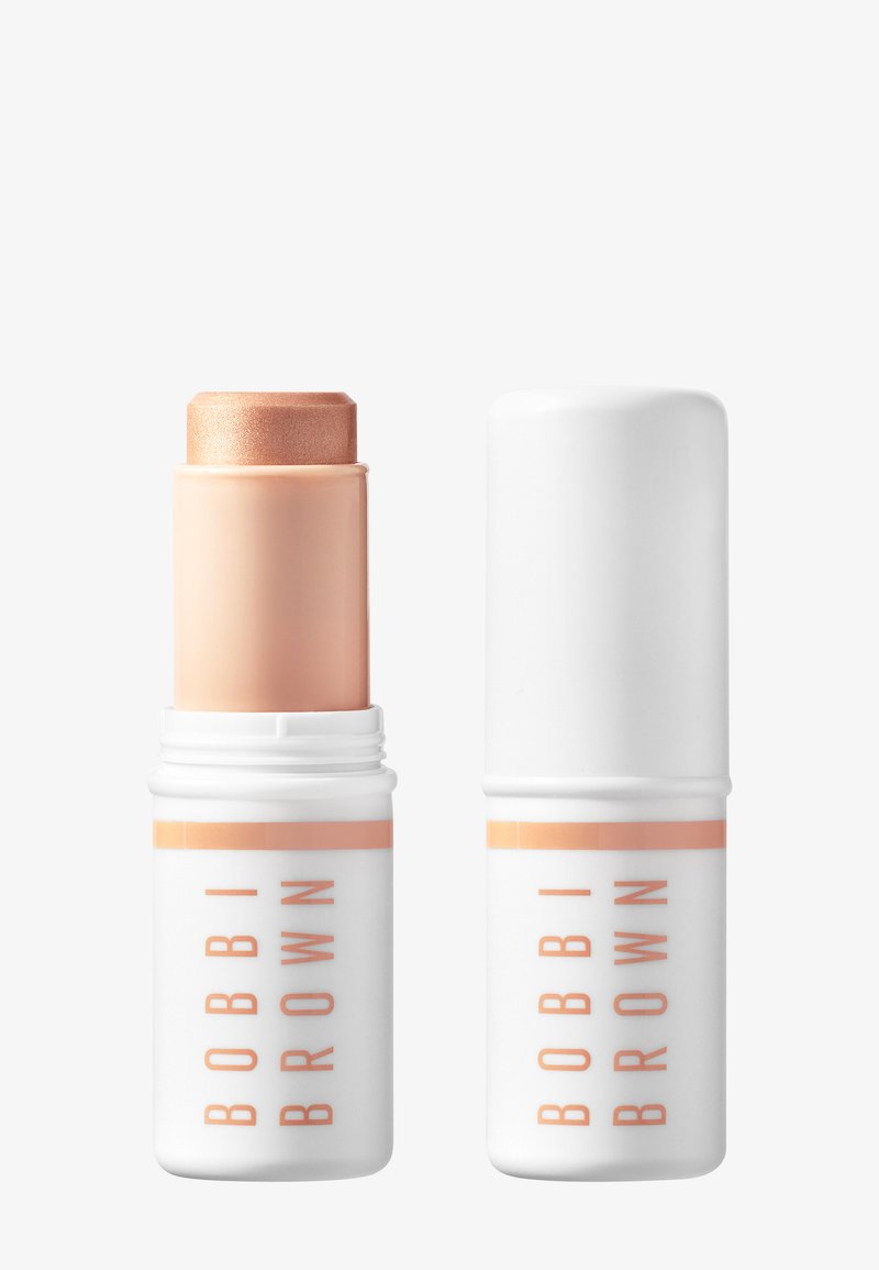 Bobbi Brown makeup stick in beige tone with white cap, shown open and closed side by side on white background.