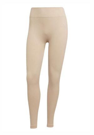 Beiga leggings i stretcht tyg med ribbat mönster, utrustade med elastisk midja och minimal logotyp.