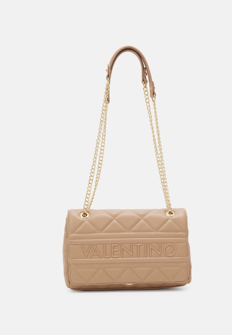 Quilted beige handbag with gold chain straps, featuring embossed "VALENTINO" logo and smooth texture, rectangular shape.