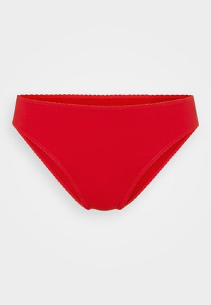 Red bikini bottom featuring smooth fabric, a low-rise design, scalloped edges at the waistband, and a minimalist style without additional patterns.