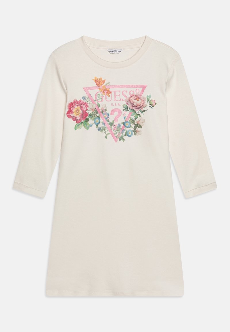 Vestido de manga larga color crema con un diseño floral y un logo triangular rosa con el texto "GUESS U.S.A." centrado en el frente.