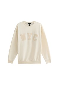 Krämfärgad sweatshirt med ribbade ärmslut och nederkant, med "NYC" i en texturerad, broderad design. Mjuk material och avslappnad passform.