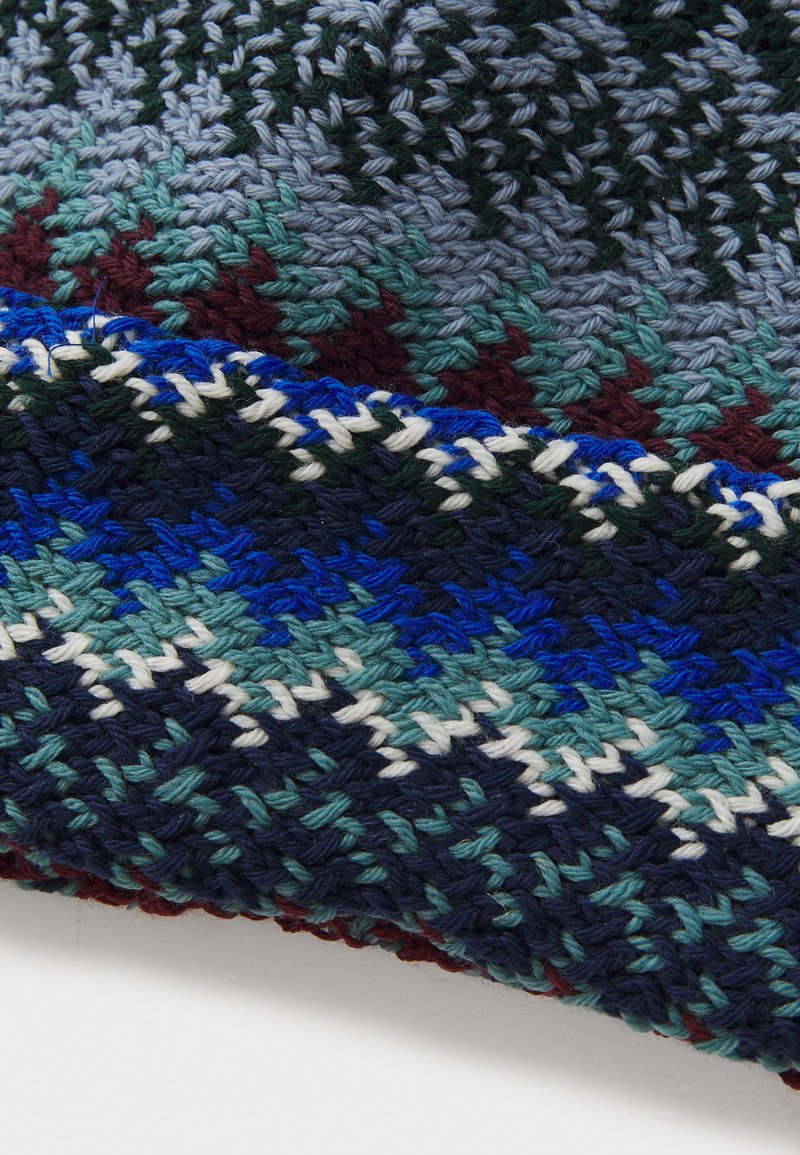 Woven textile with geometric patterns in dark blue, green, and maroon. Features a textured, multi-colored design with contrasting stripes.