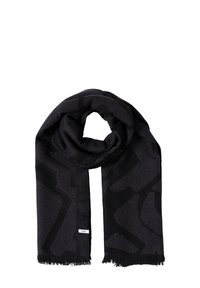 Écharpe noire présentant un motif géométrique dans des tons sombres, fabriquée en tissu doux avec un léger éclat et des bords frangés. Étiquette de marque sur le côté.