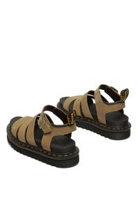 Sandali in tessuto marrone con cinturini larghi e suola nera testurizzata. Presentano una chiusura con fibbia e cuciture gialle a contrasto.
