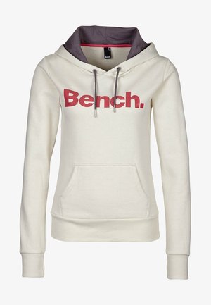 Sweat à capuche couleur crème avec capuche doublée de bordeaux, poche frontale, cordons de serrage et logo "Bench." rouge vif en travers de la poitrine.