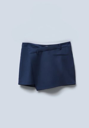 Marineblauwe shorts met een platte voorkant, zijzakken en een achterzak. Glad materiaal met een gepolijste uitstraling en gestikte accenten.