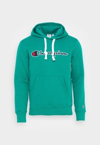 Turkoosi fleecetakki hupulla, jossa on etutasku, valkoiset nyörit ja rintapielessä punainen ja tummansininen "Champion"-logo. Resorit hihansuissa ja helmassa.