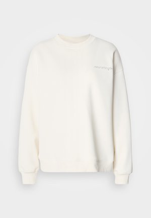 Vaaleanbeige collegepaita pyöreällä pääntiellä, resorikäärityillä hihoilla ja helmalla. Edessä hienovarainen kirjailtu teksti. Pehmeä materiaali, jossa sileä pinta.