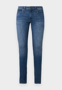 Τζιν στενής γραμμής σε σκούρο μπλε denim, με πέντε τσέπες, φερμουάρ και ελαφριά ξεθώριασμα κατά μήκος των ποδιών. Κλαστική ραφή και ελαφριά ελαστικότητα.