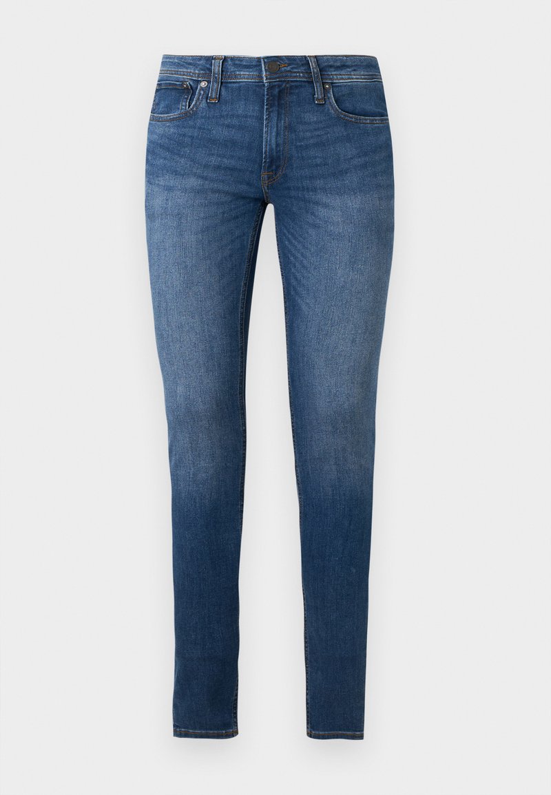 Τζιν στενής γραμμής σε σκούρο μπλε denim, με πέντε τσέπες, φερμουάρ και ελαφριά ξεθώριασμα κατά μήκος των ποδιών. Κλαστική ραφή και ελαφριά ελαστικότητα.