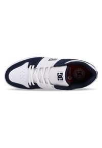 White and navy sneaker with a padded tongue, lace-up front, perforated toe, and rubber sole. Features a logo patch on the tongue.
