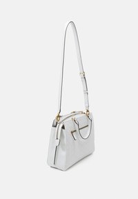 Bílá kožená kabelka s pevnou strukturou, zlatým kováním, zipovým zapínáním a odnímatelným popruhem. Vyznačuje se prošívanou texturou a akcentním šitím.