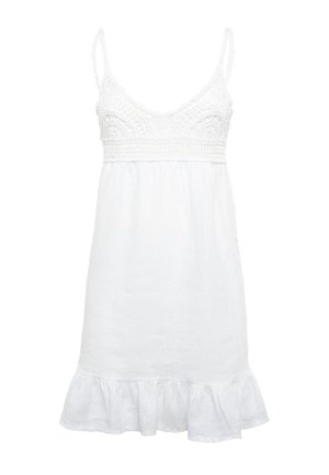 Robe en lin blanc avec des bretelles spaghetti ajustables, un corsage en crochet et un ourlet à volants en bas. Coupe décontractée pour plus de confort.