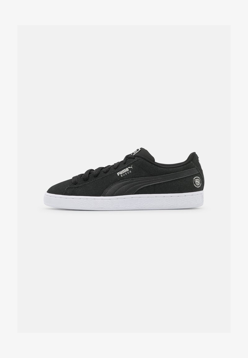 Mustad nahast tenniseketid valge kummist tallaga, millel on ümar varvas, ühesugused paelad ja Puma logo küljel brändingu jaoks.