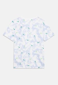 Fehér rövid ujjú póló világoskék absztrakt mintával, szórványosan zöld és sötétkék Nike logókkal. Puha pamut anyag.