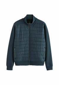 Veste bleu canard foncé avec fermeture éclair à l'avant, présentant des panneaux supérieurs matelassés et des sections inférieures solides. Col et poignets côtelés. Poches latérales zippées.