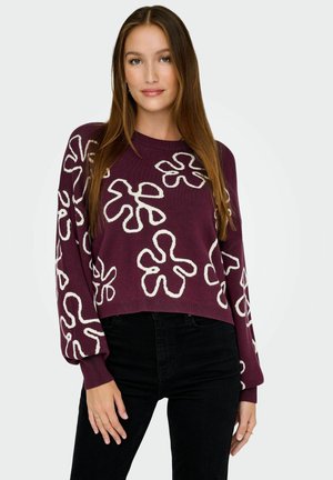 Pull bourgogne avec des motifs floraux abstraits blancs, col rond et manches longues. Matière en tricot légère, coupe cropped.