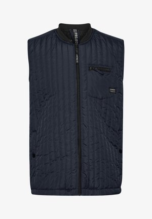 Navy kamizelka pikowana z wysokim kołnierzem, zamkiem z przodu i kieszenią na klatce piersiowej. Posiada kieszenie boczne oraz fakturowany wzór materiału.