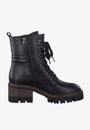 Black leather ankle boots with a textured finish, featuring metallic eyelets, laces, and a side zipper. Chunky, ridged rubber sole with a block heel.